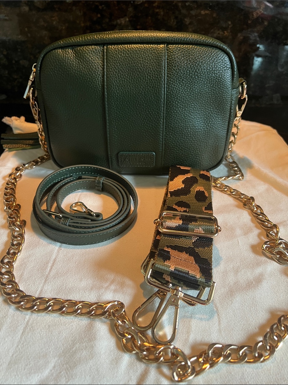 Pom Pom London Vintage Green City Crossbody Bag with three straps.
